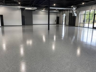 Open commercial floor finished in a grey flake system