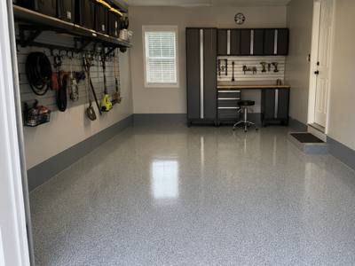 Grey flake floor in a single bay garage fitted out for storage